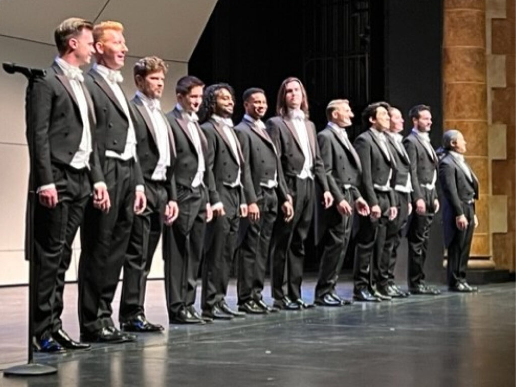 A group of men in suits standing on the stage.