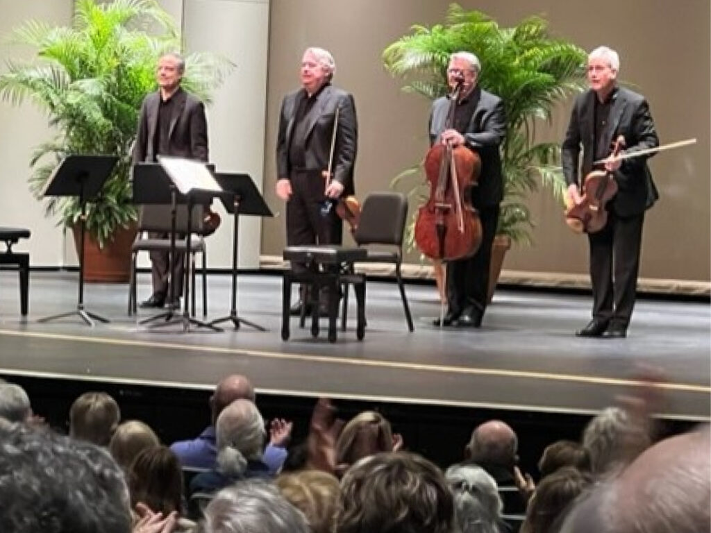 A group of men on stage playing instruments.