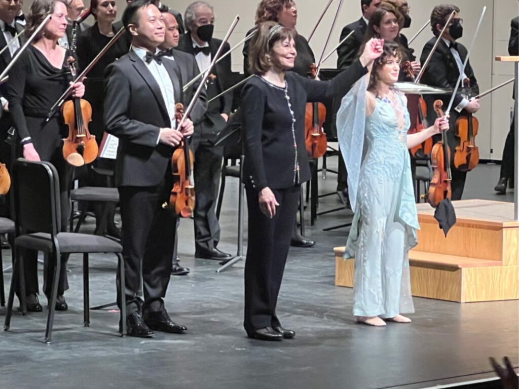 A group of people standing on top of a stage.